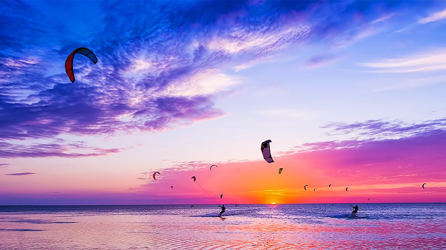 Kite surfing at sunset time
